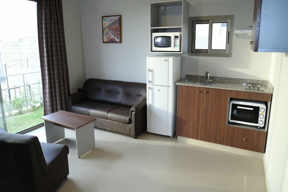 Full-size fridge, microwave, stovetop, cookware/dishes/utensils