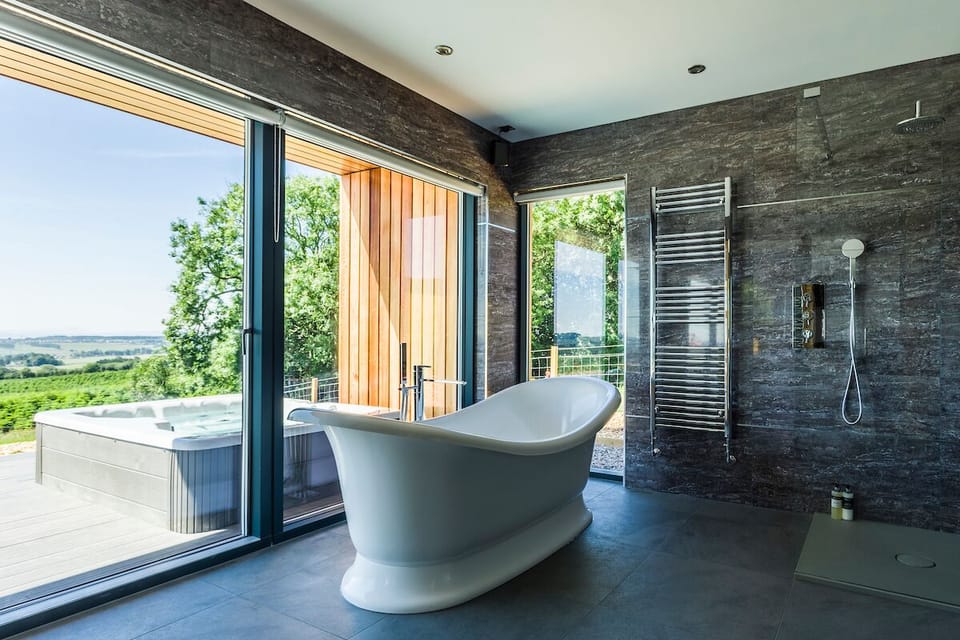 Executive Suite, 1 King Bed, Hot Tub | Bathroom | Separate tub and shower, deep soaking tub, rainfall showerhead