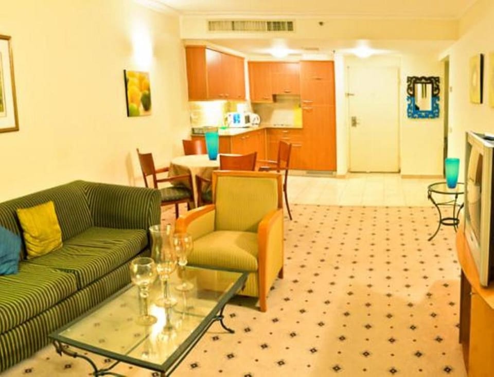 Deluxe Apartment, 1 Bedroom, Sea View, Beachfront | Living room | Flat-screen TV