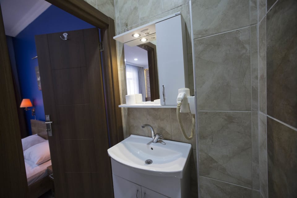 Shower, free toiletries, hair dryer, slippers