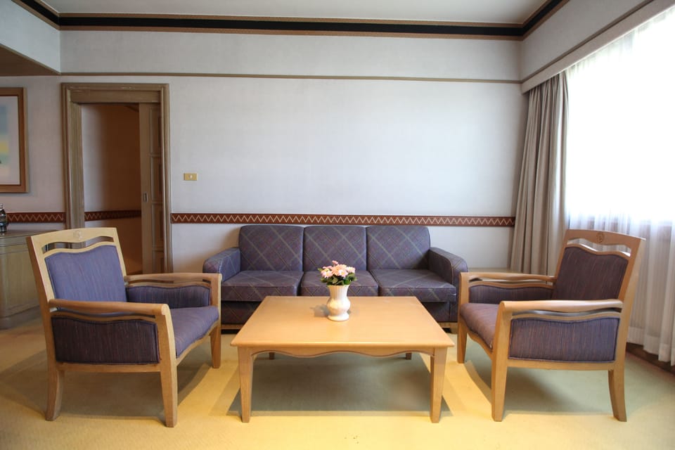 Junior Suite | Living room | 32-inch LCD TV with cable channels