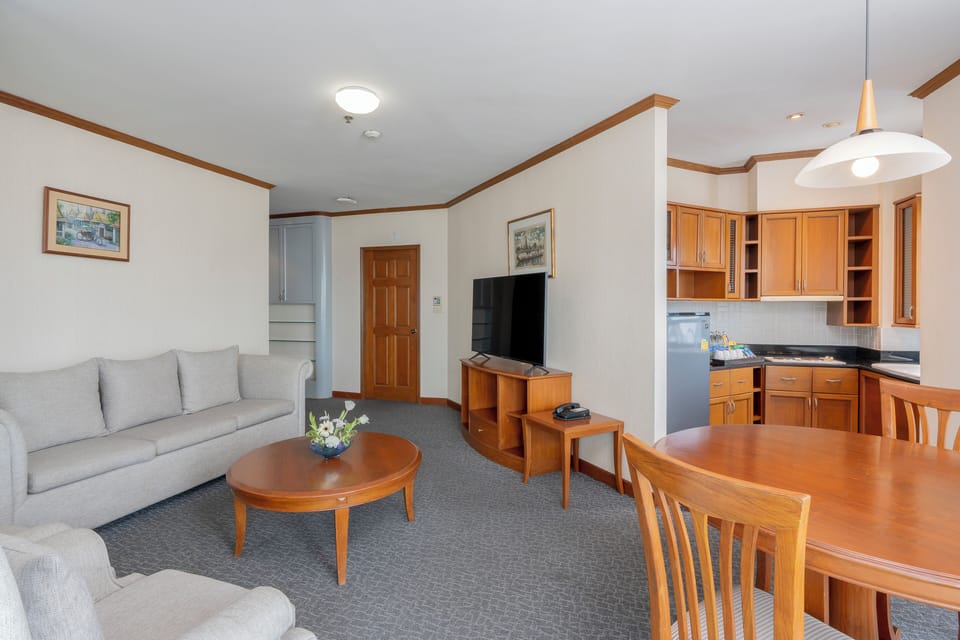 Executive Suite, 2 Bedrooms | Living area | 32-inch LCD TV with cable channels, TV, pay movies