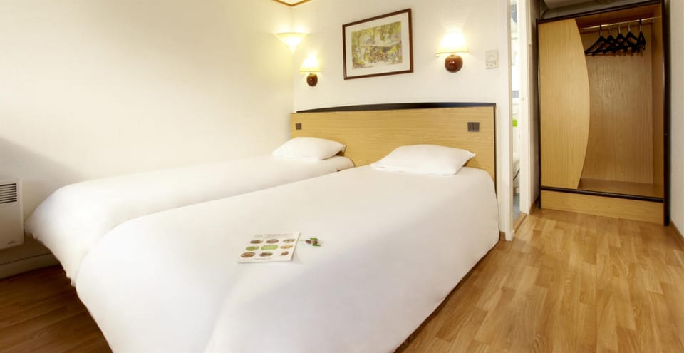 Premium bedding, desk, laptop workspace, blackout drapes