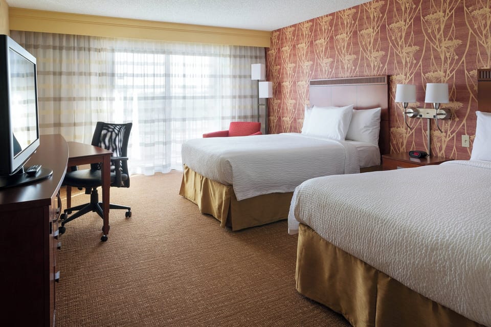 Premium bedding, desk, laptop workspace, blackout drapes