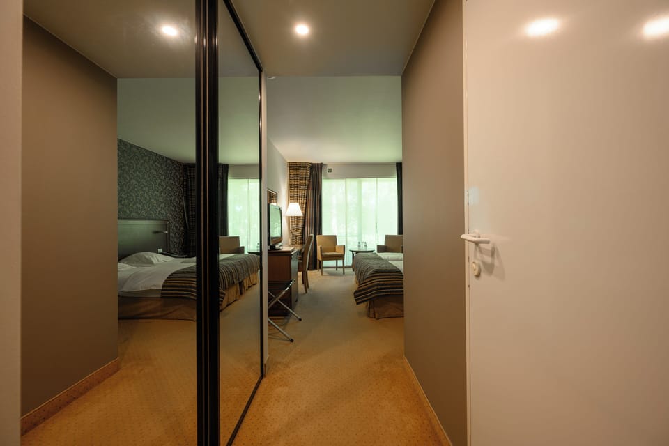 Deluxe Double Room, River View | In-room safe, desk, laptop workspace, iron/ironing board