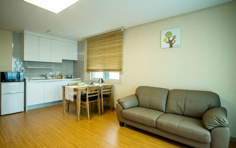 Family Room, 1 Bedroom, Kitchenette, Partial Sea View | Living area | 40-inch flat-screen TV with cable channels, TV, pay movies