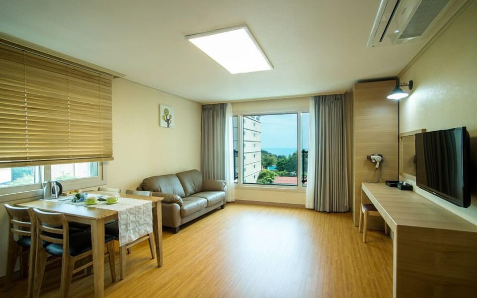 Family Room, 1 Bedroom, Kitchenette, Partial Sea View | Living area | 40-inch flat-screen TV with cable channels, TV, pay movies