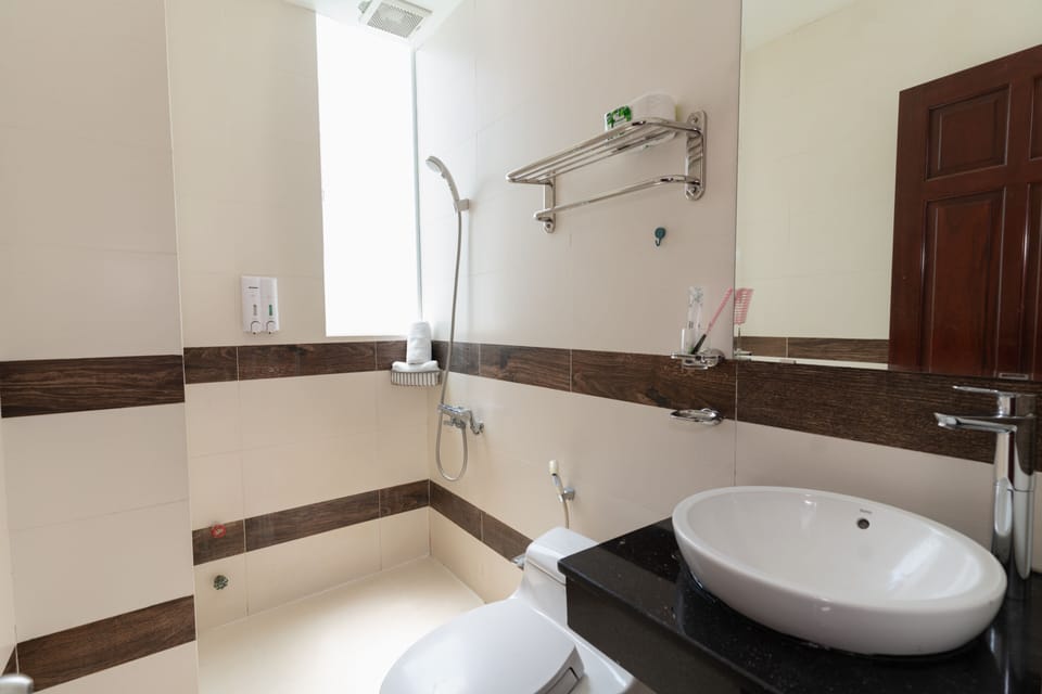 Shower, designer toiletries, hair dryer, slippers