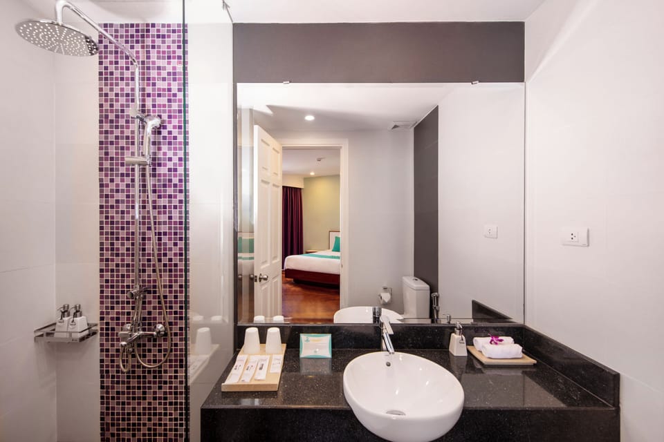 Shower, designer toiletries, hair dryer, bathrobes