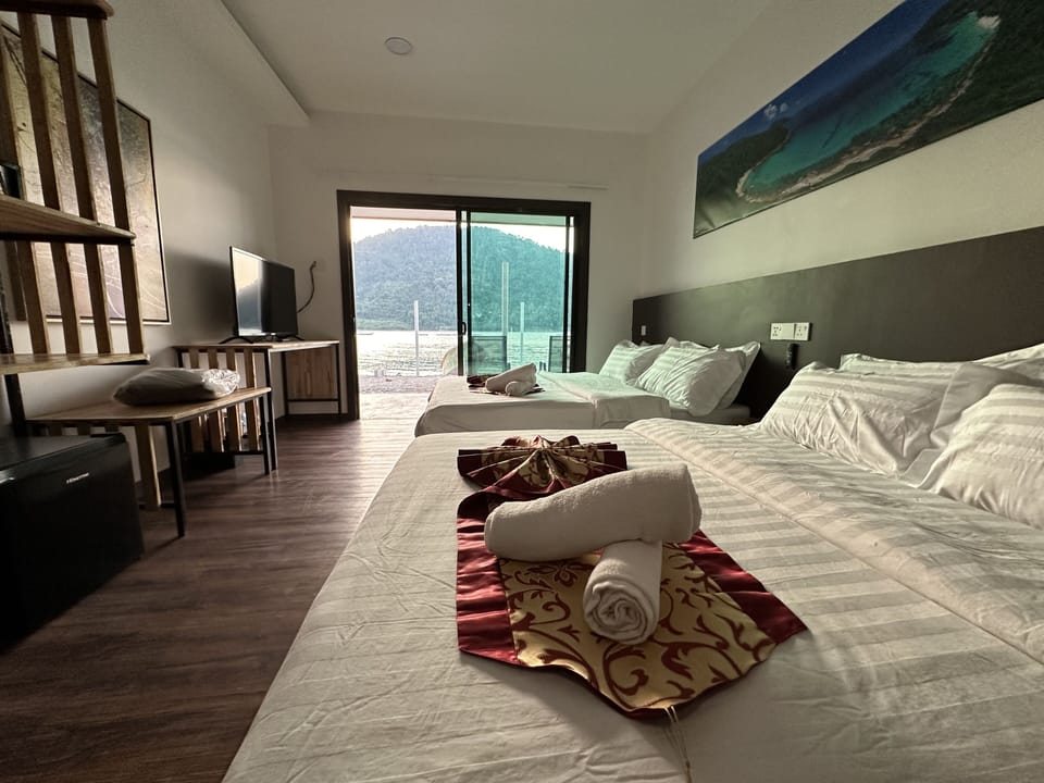 Seafront Family Room | In-room safe, desk, iron/ironing board, bed sheets