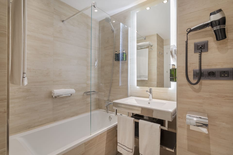 Designer toiletries, hair dryer, towels, soap