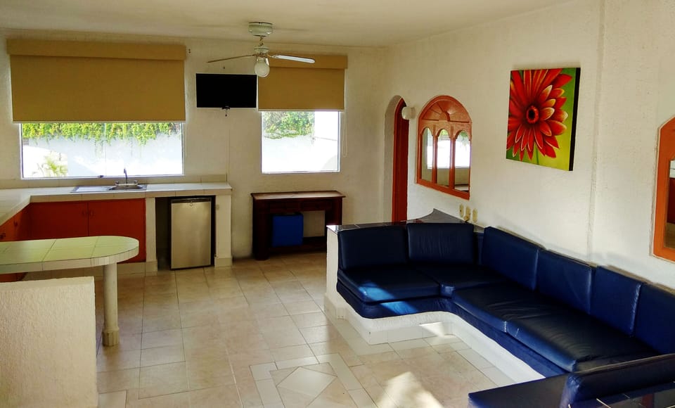 Junior Suite, 2 Bedrooms, Poolside | Living room | 32-inch TV with cable channels