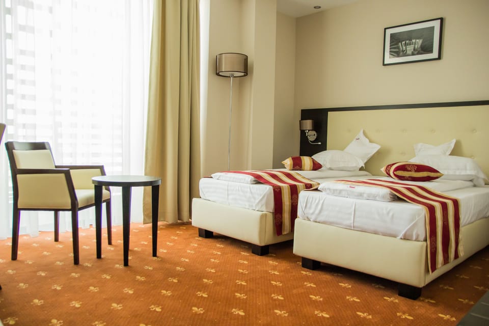 Standard Twin Room | Minibar, in-room safe, desk, soundproofing