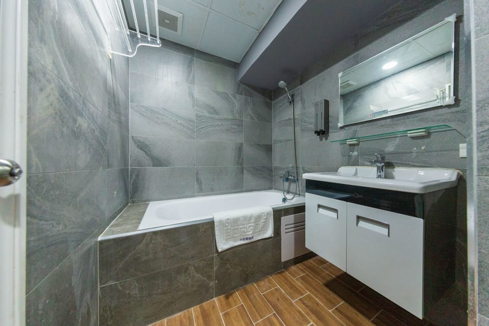 Deluxe Quadruple Room, Bathtub, City View | Bathroom | Combined shower/tub, rainfall showerhead, free toiletries, hair dryer