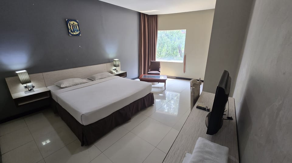 Desk, laptop workspace, blackout drapes, bed sheets