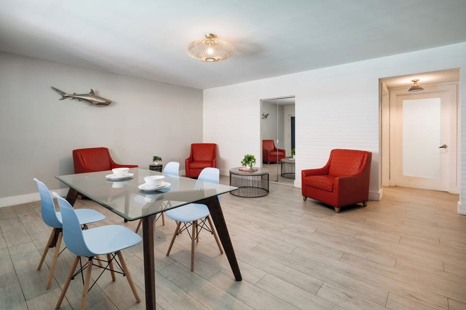 Deluxe One Bedroom Queen Suite | Living area | 42-inch flat-screen TV with cable channels, TV, iPod dock