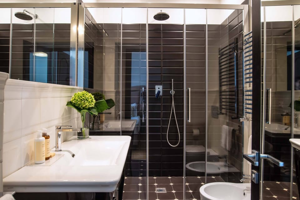 Suite, City View | Bathroom | Shower, eco-friendly toiletries, hair dryer, slippers