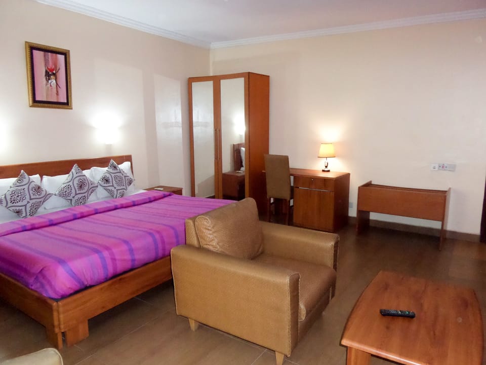 Premium bedding, desk, laptop workspace, blackout drapes