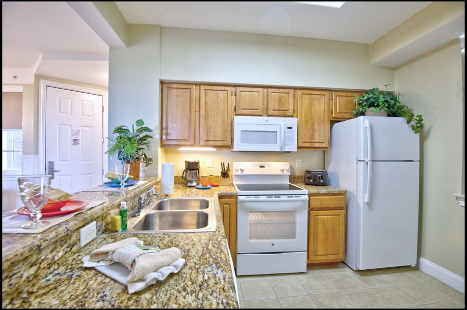 Microwave, coffee/tea maker, cookware/dishes/utensils, cleaning supplies