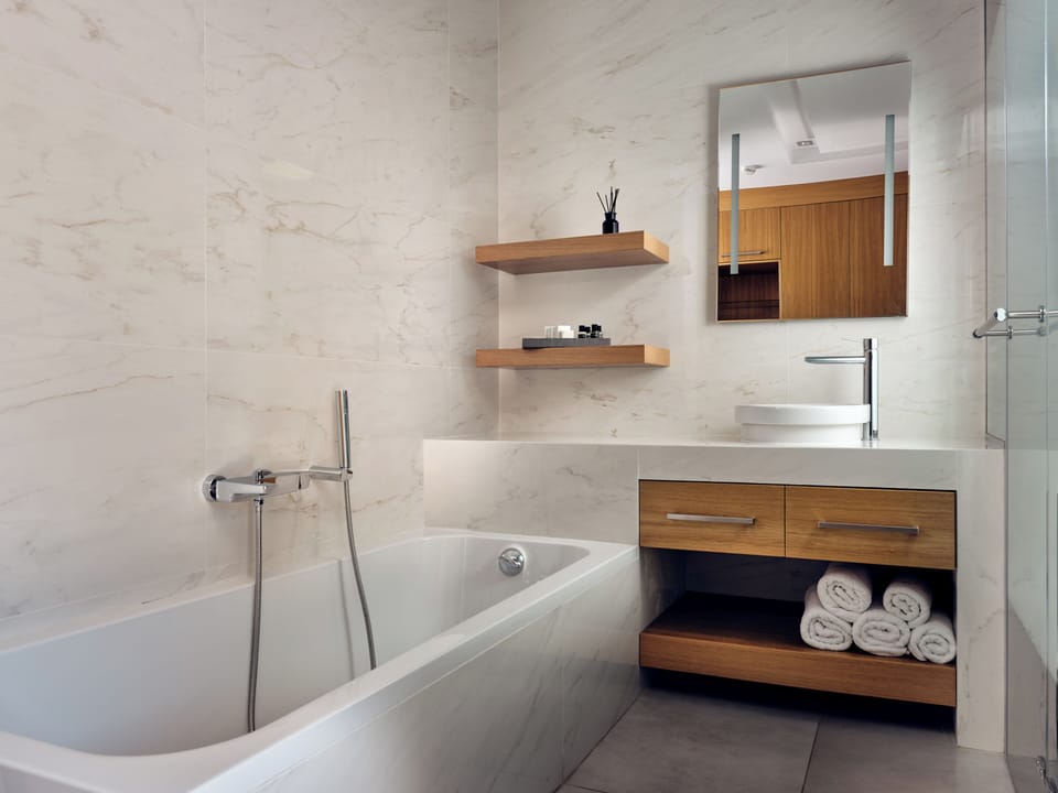 Separate tub and shower, designer toiletries, hair dryer, bathrobes