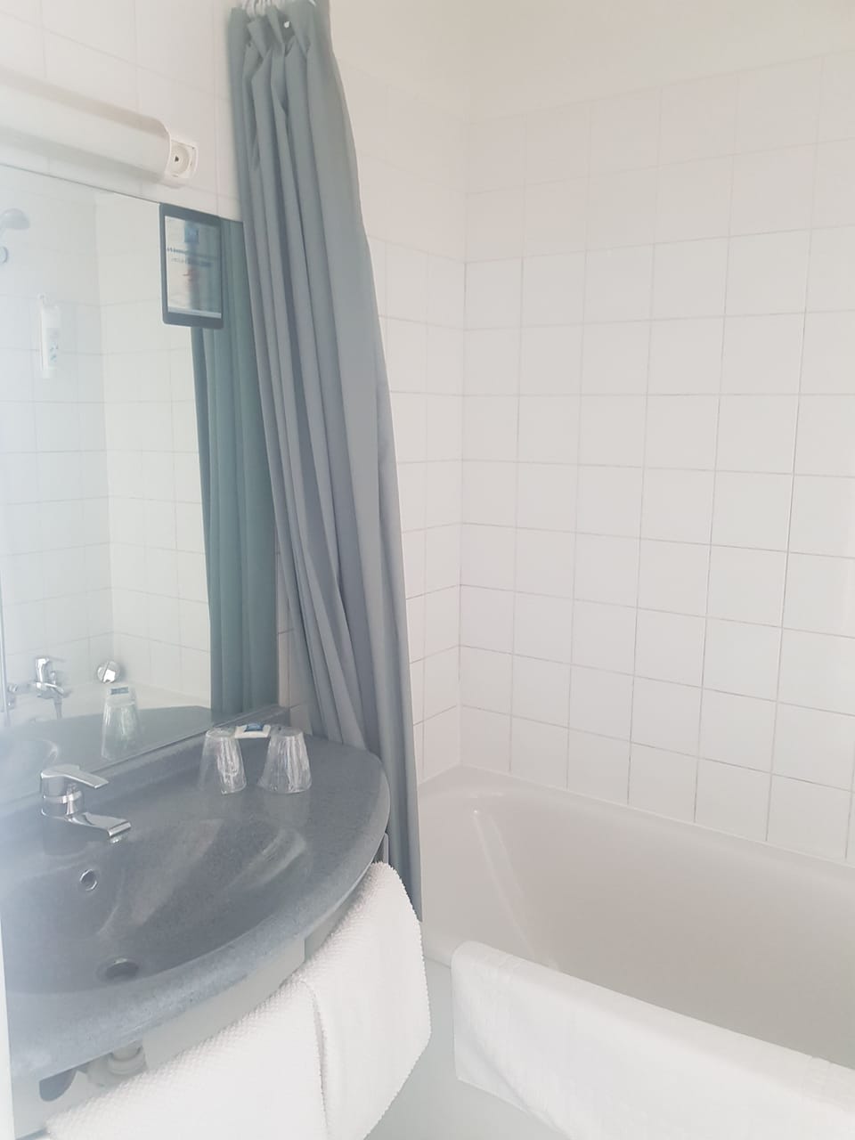 Bathtub, eco-friendly toiletries, towels