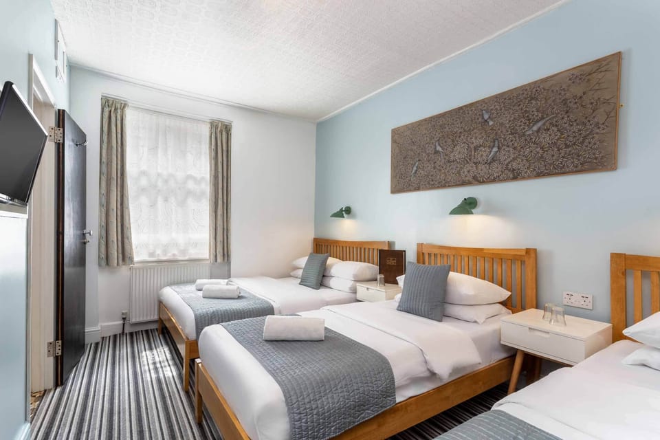 Quad room with private bathroom | Individually decorated, individually furnished, blackout drapes