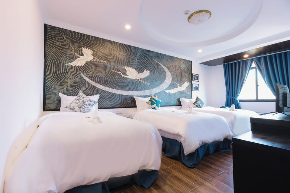 Family Triple Room | Minibar, in-room safe, desk, blackout drapes