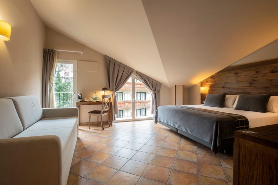 Superior Quadruple Room | Minibar, in-room safe, desk, laptop workspace