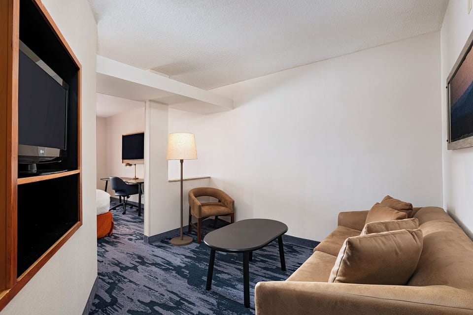 Suite, 1 King Bed with Sofa bed | Living area | 32-inch LCD TV with cable channels, TV