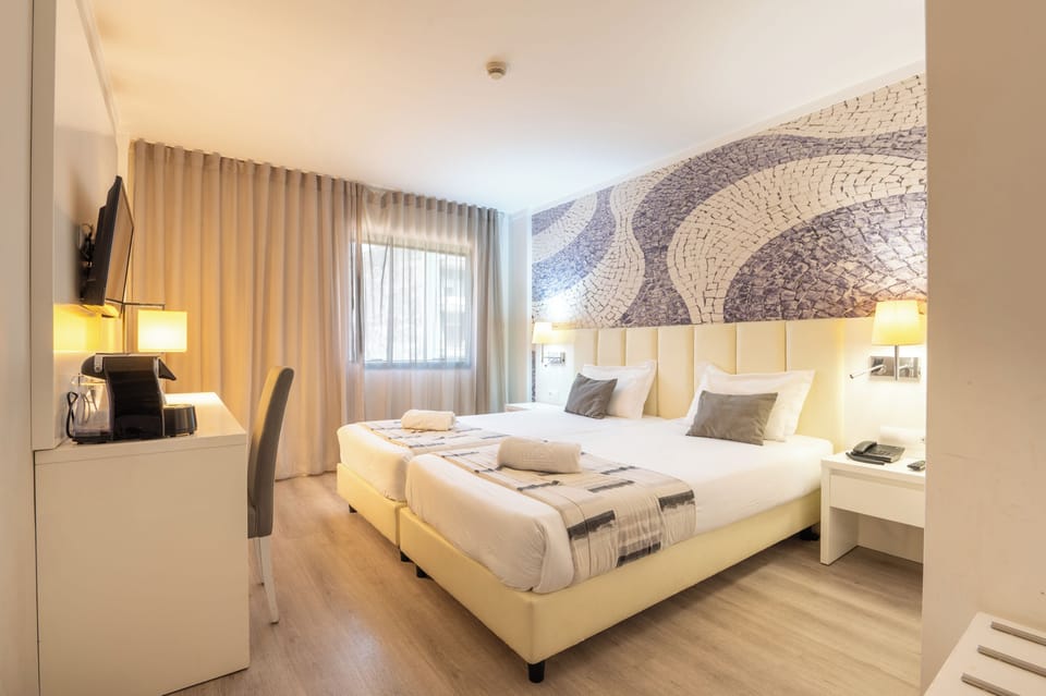 Twin Room | Minibar, in-room safe, desk, soundproofing