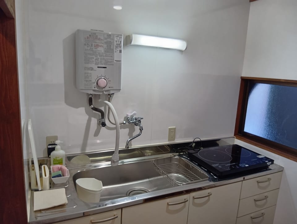 Japanese Style Townhouse | Private kitchen | Full-size fridge, microwave, stovetop, coffee/tea maker