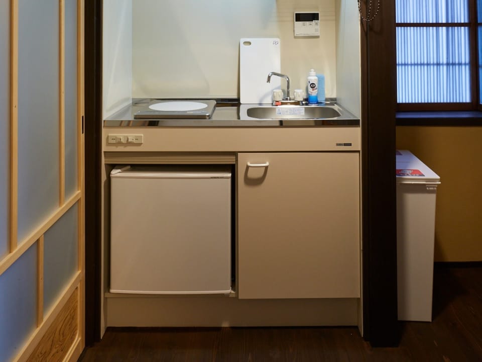 Japanese Style Townhouse | Private kitchen | Fridge, coffee/tea maker, electric kettle, cookware/dishes/utensils