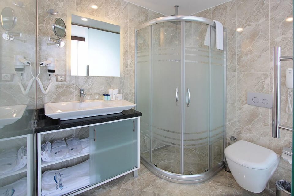 Shower, hair dryer, slippers, towels