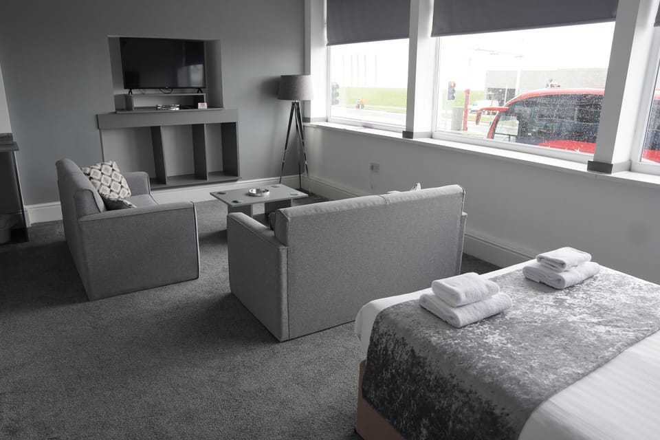 Superior Suite, Sea View | Living area | Flat-screen TV