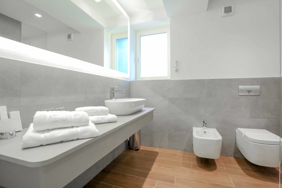 Shower, designer toiletries, hair dryer, slippers