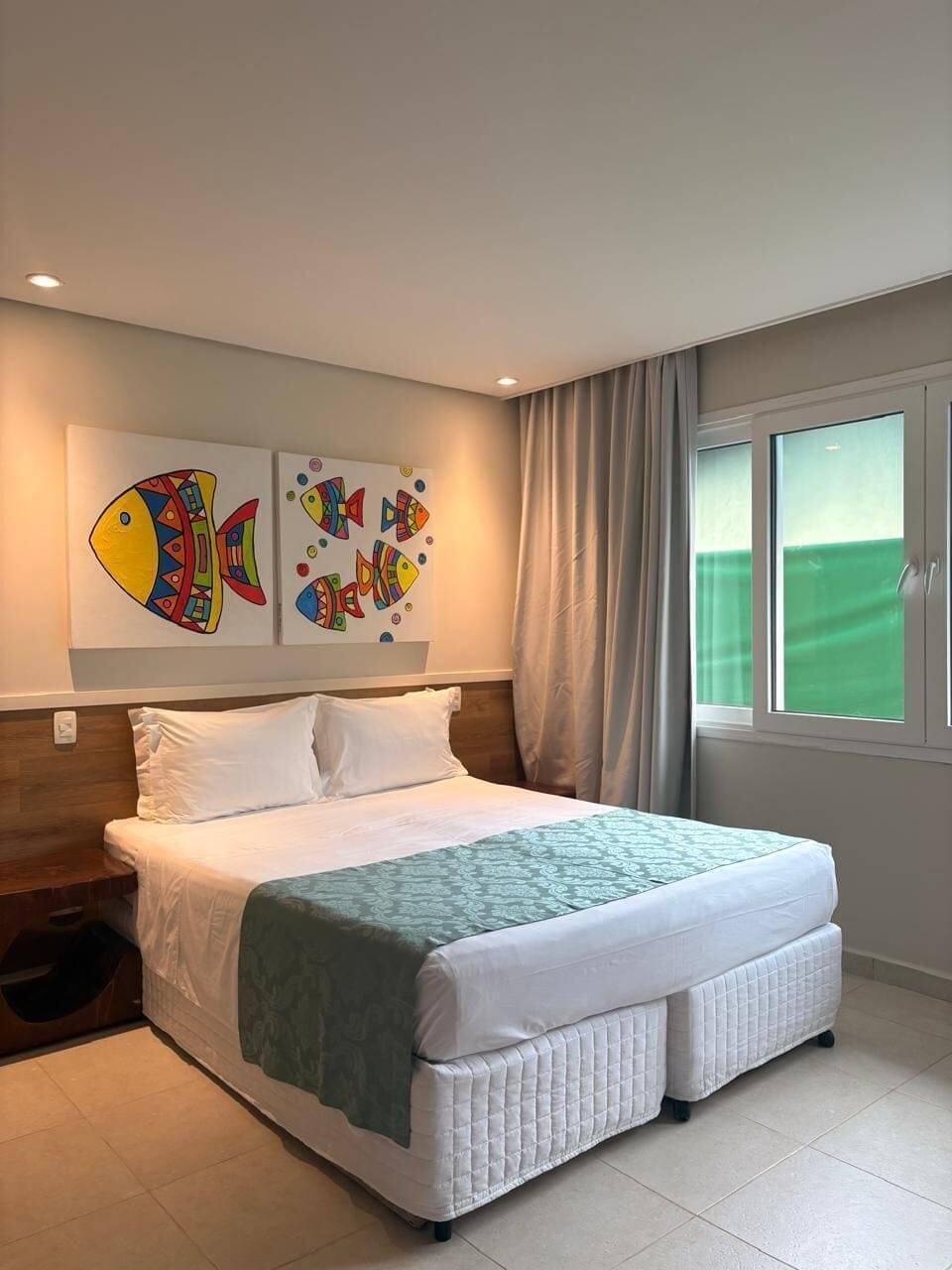 Deluxe Room, Partial Sea View | Minibar, in-room safe, soundproofing, bed sheets