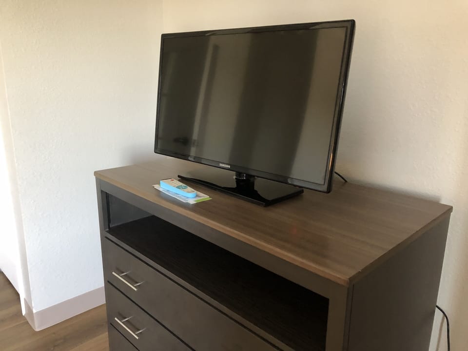 Premium bedding, desk, laptop workspace, blackout drapes