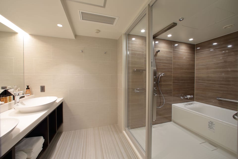 Suite, 2 Queen Beds | Bathroom | Combined shower/tub, rainfall showerhead, designer toiletries