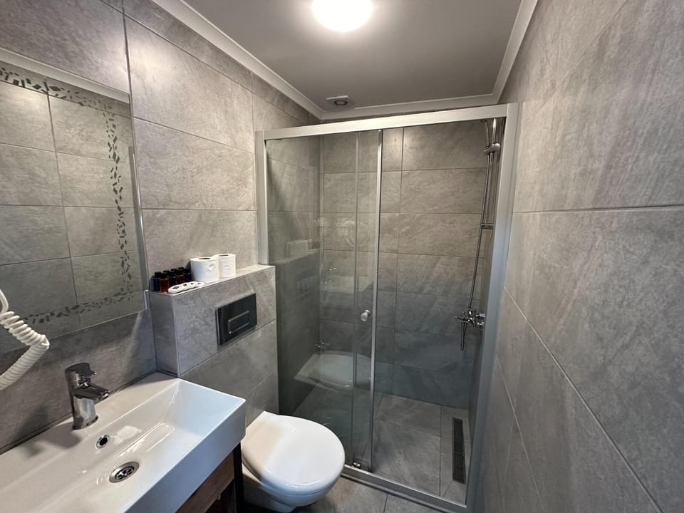 Shower, hair dryer, slippers, towels