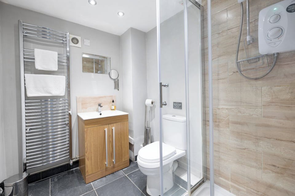 Shower, hair dryer, slippers, towels