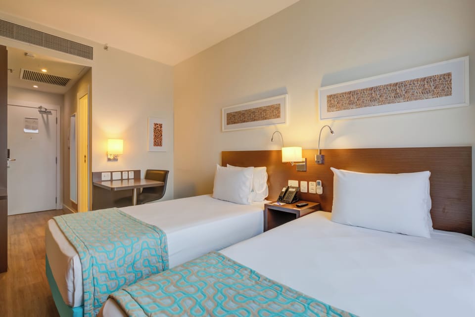 Superior Twin Room | Minibar, in-room safe, desk, blackout drapes