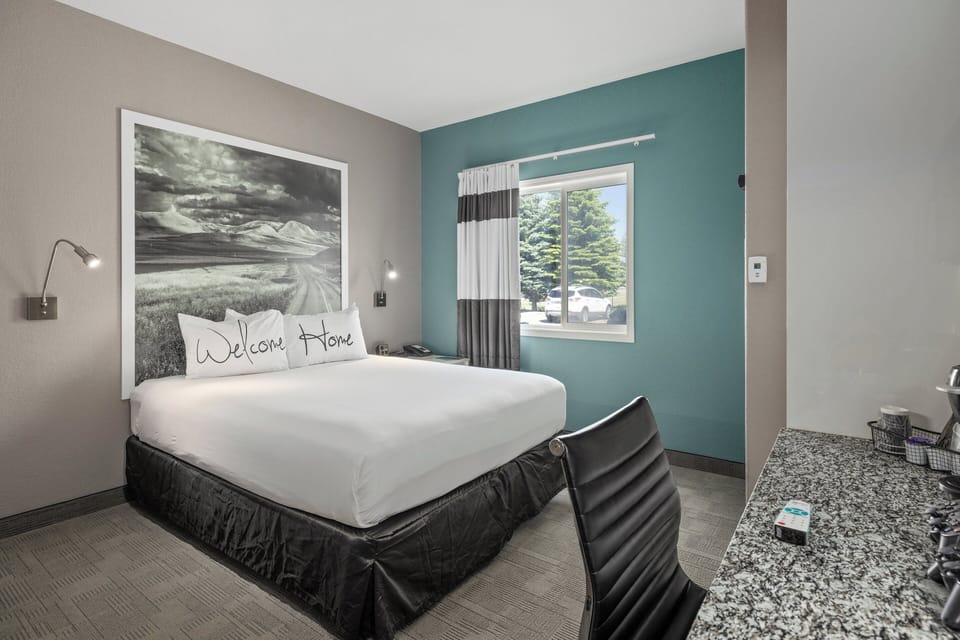 Premium bedding, desk, laptop workspace, blackout drapes