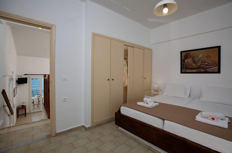 Apartment, 1 Bedroom, Sea View | 1 bedroom, blackout drapes, iron/ironing board, free WiFi