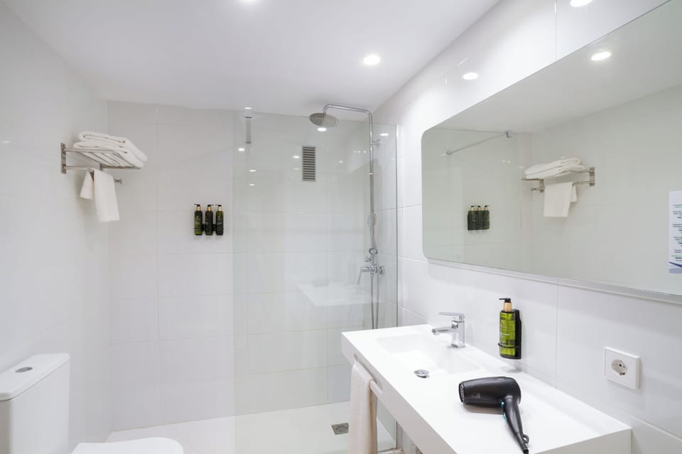 Shower, rainfall showerhead, hair dryer, towels