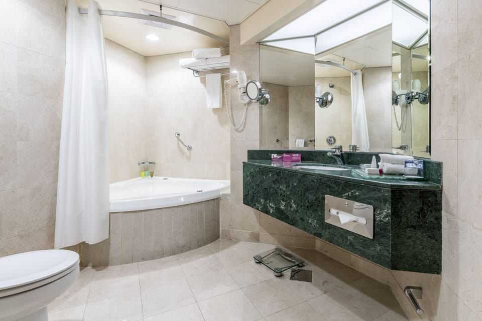 Deep soaking tub, rainfall showerhead, eco-friendly toiletries