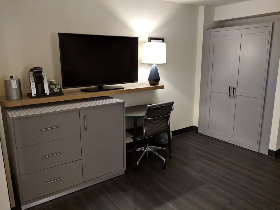 Desk, laptop workspace, blackout drapes, iron/ironing board