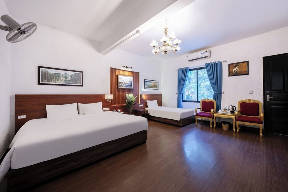 Deluxe Family Room | Minibar, in-room safe, blackout drapes, iron/ironing board