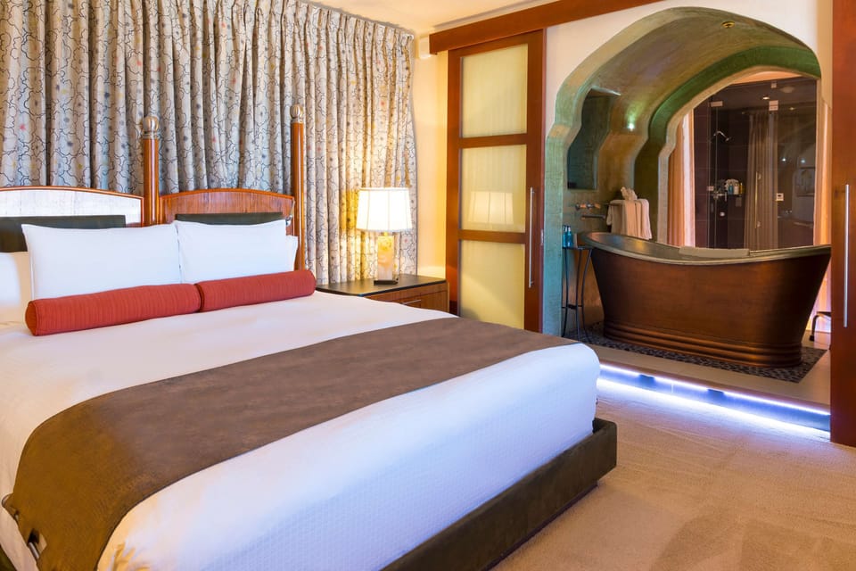 Suite, 1 King Bed | Bathroom | Combined shower/tub, designer toiletries, hair dryer, bathrobes