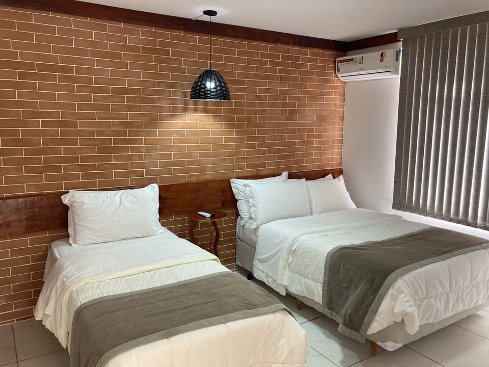 Standard Triple Room | Minibar, laptop workspace, blackout drapes, iron/ironing board