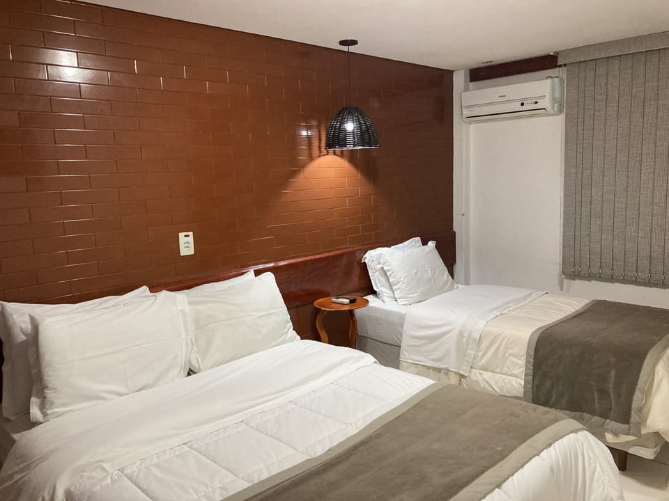 Standard Triple Room | Minibar, laptop workspace, blackout drapes, iron/ironing board